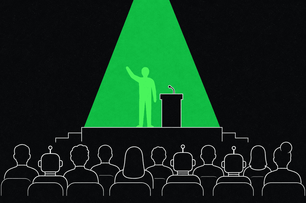A green figure presenting on a stage under a green spotlight to an audience of humans and robots